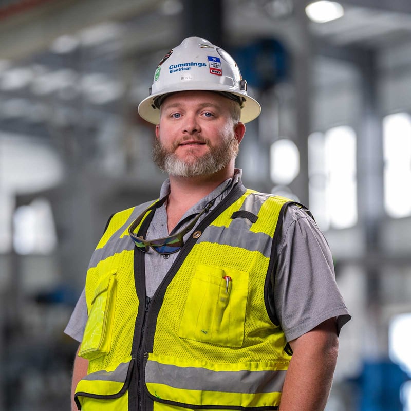 Electrician using hard hat and a safety vest