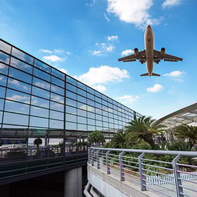 airplane flying over airport