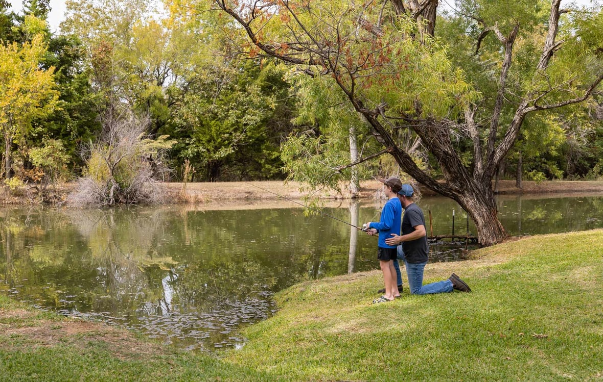 father and son fishing at a local pond