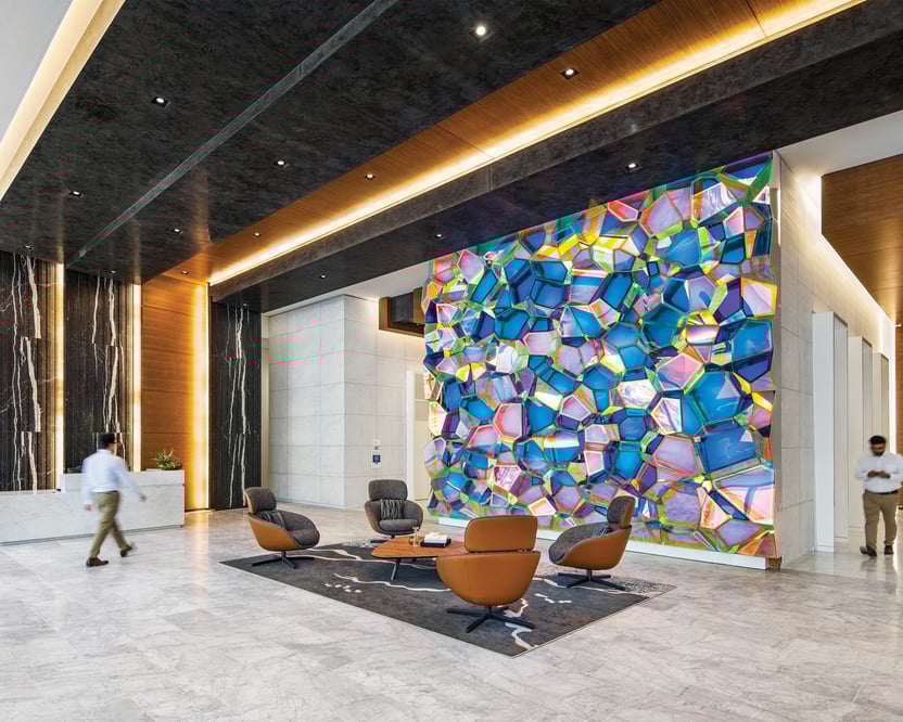 indoor view of a contemporary lobby area with colorfully designed wall art and modern lighting