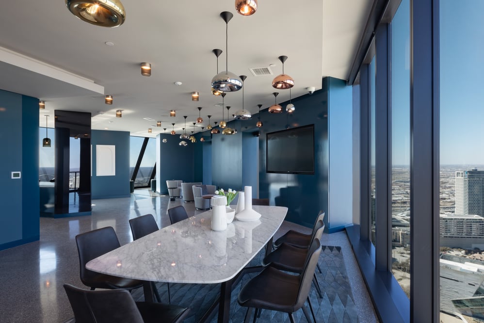 A room inside of a high-rise building overlooking the downtown cityscape