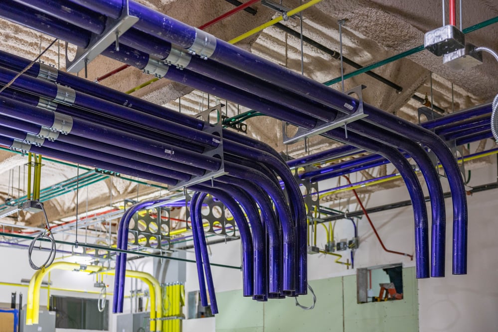 ceiling view of cleanly routed blue conduit