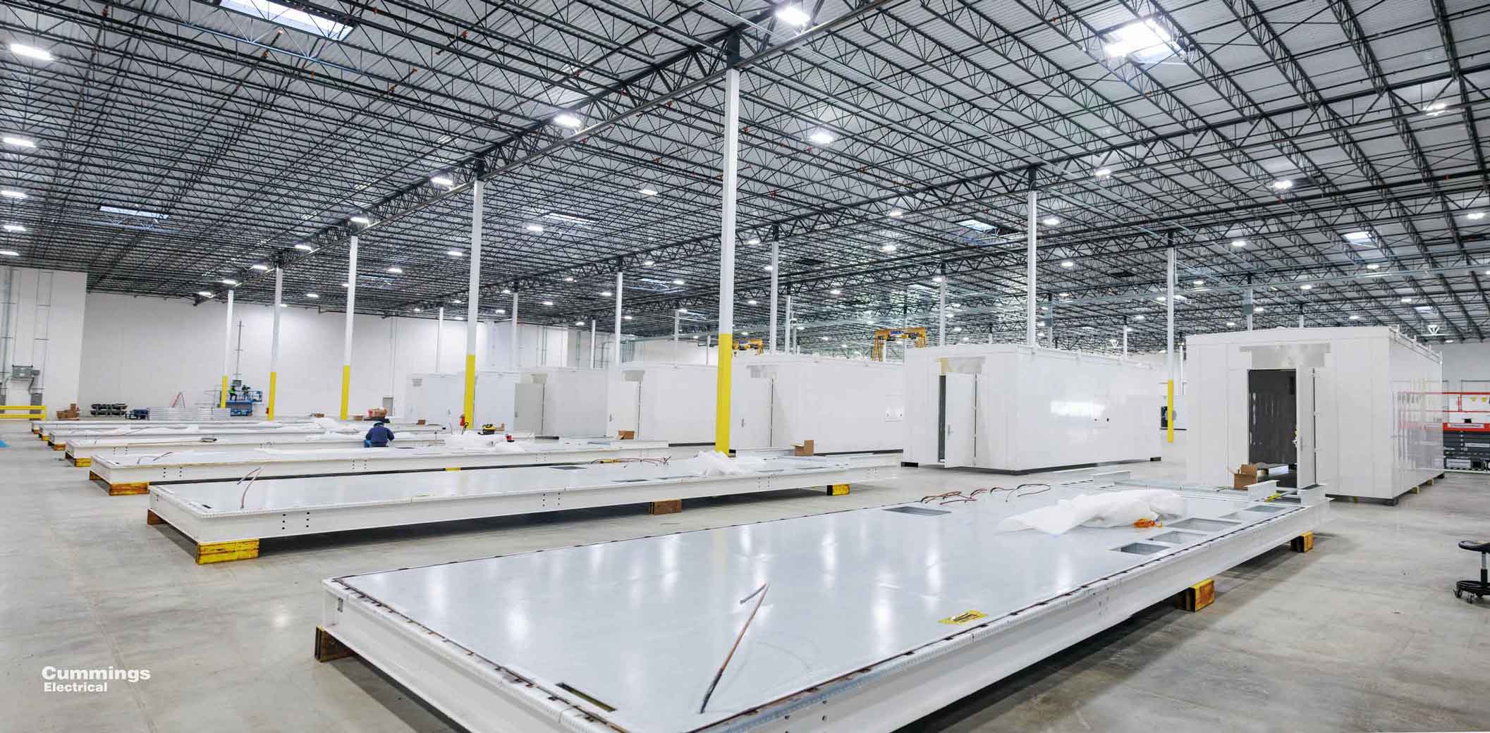 Inside of an integrated manufacturing facility with e-houses and skids.