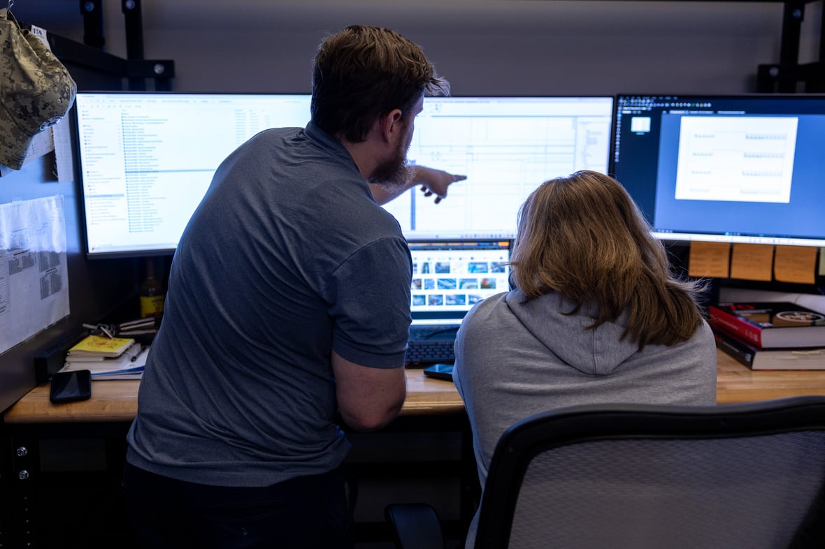 two men working on engineering project at a desk