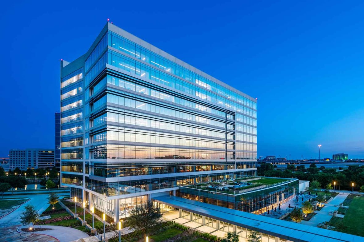 Modern high-rise office building with lighting throughout the building