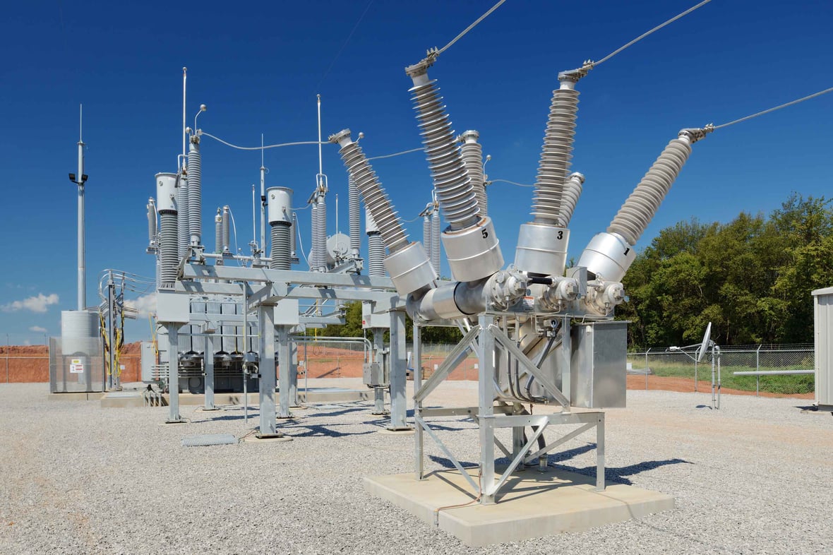 Close-up view of high-voltage substation equipment under a blue sky