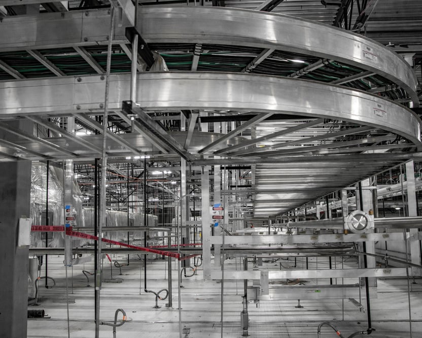 inside view of a manufacturing facility with metal conveyors