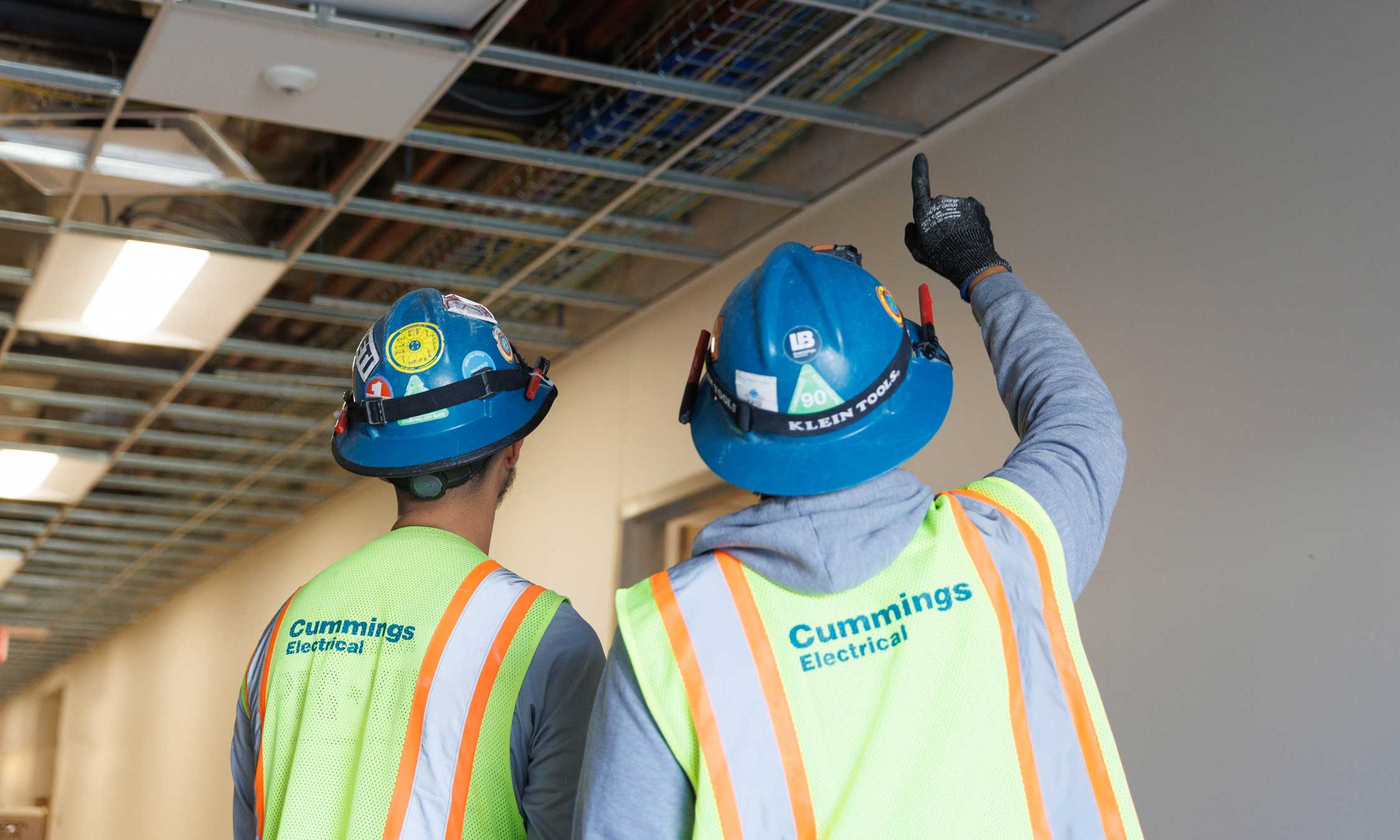 Two-Cummings-electricians-assessing-a-buildings-infrastructure-banner