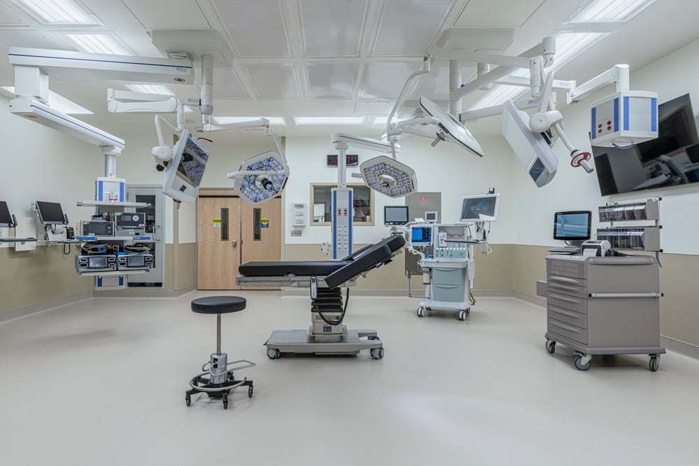 modern surgical procedure room with various medical equipment surrounding