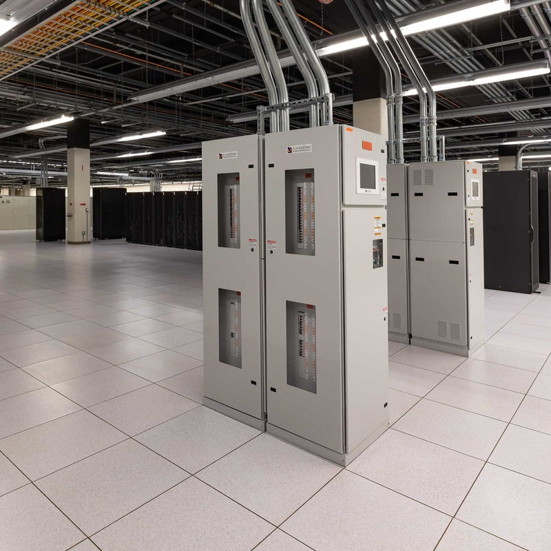 interior of a data center with rows of networking racks electrical equipment