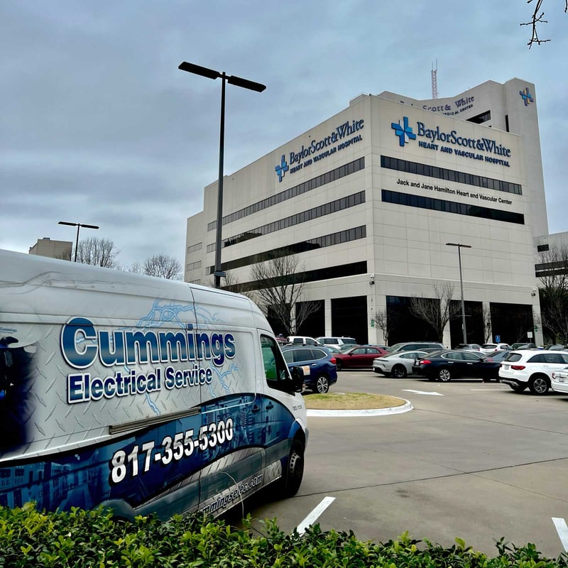 exterior view of a Baylor Scott & White Hospital with a Cummings Electrical van parked in front of the building