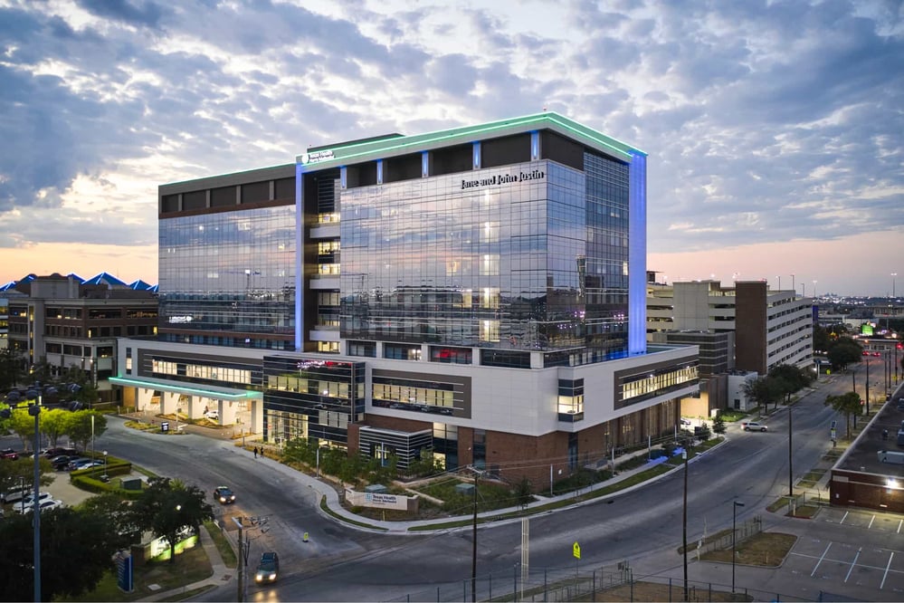 exterior sunset view of a modern medical center under a slightly cloudy sky